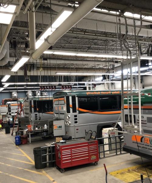 Garage with busses and overhead LED lighting